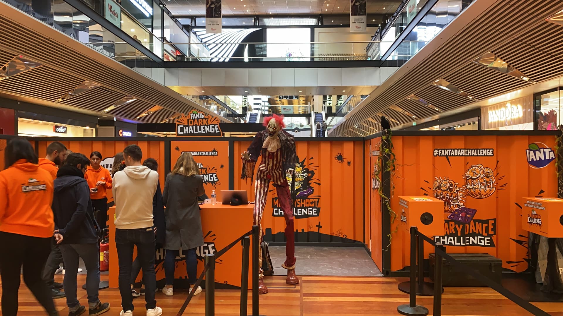 Immersive pop-up booth with corrugated metal walls and sensory challenge boxes in a mall