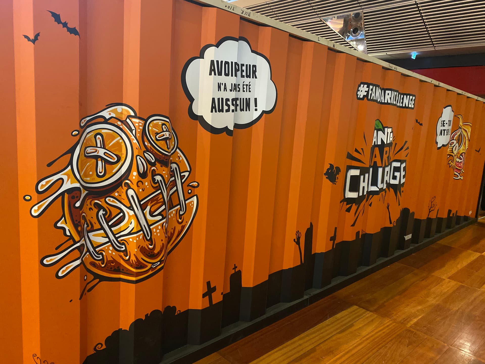 Custom painted shipping container with graphic wrap for an indoor experiential event installation