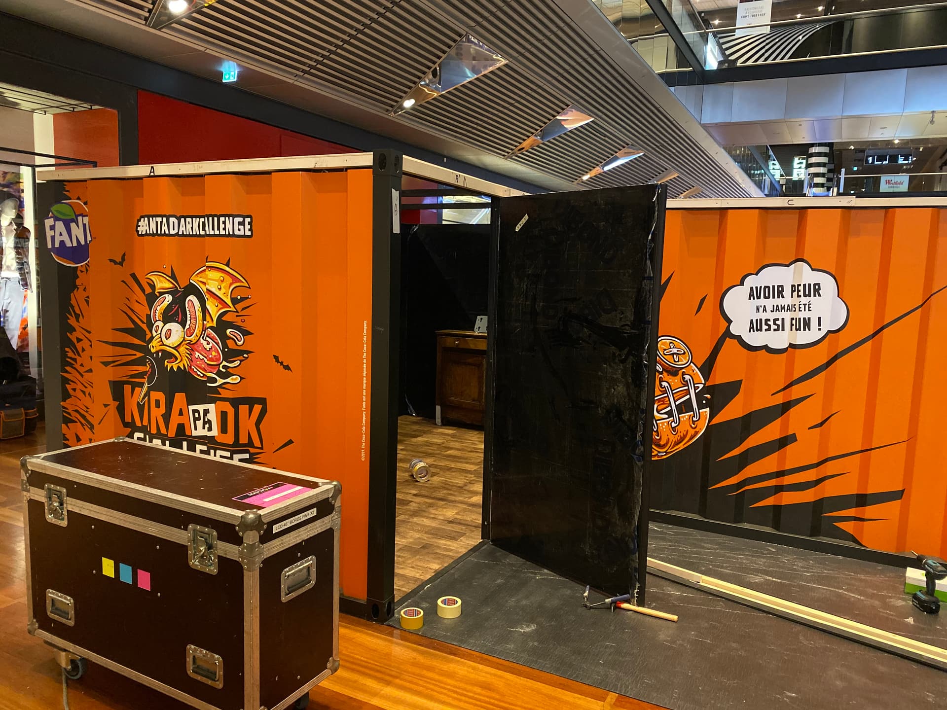 Immersive walk-in container booth during on-site assembly for a brand event activation